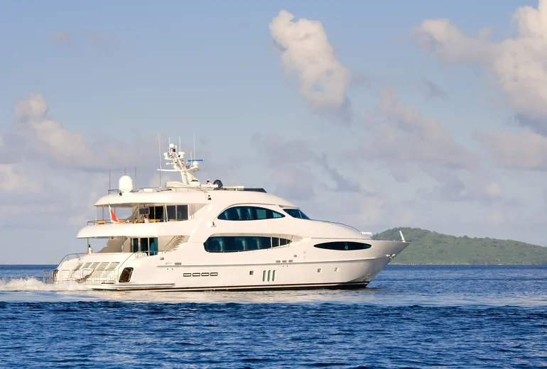 Charter yacht at a Croatian marina near a small island village