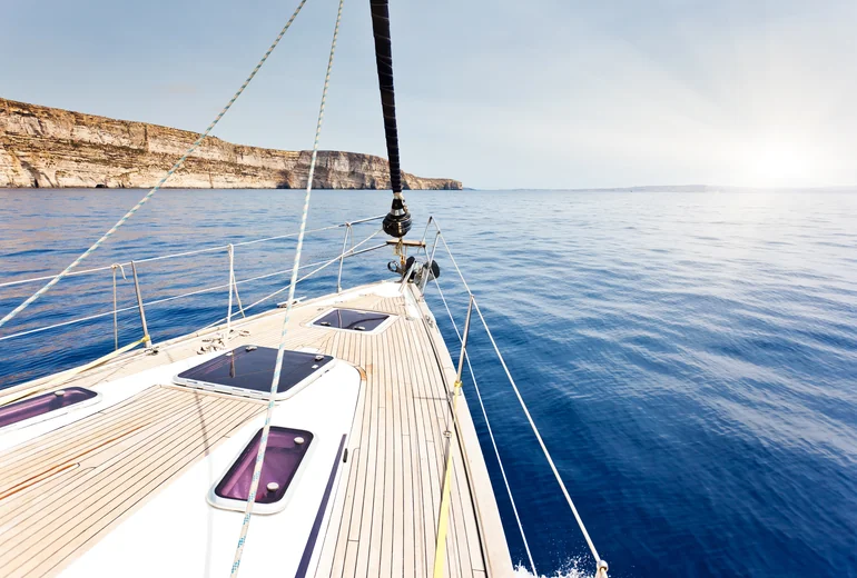 Catamaran sailing in steady wind with full canvas