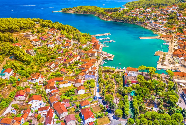 Croatian Adriatic island bay with clear water and tree-lined shore