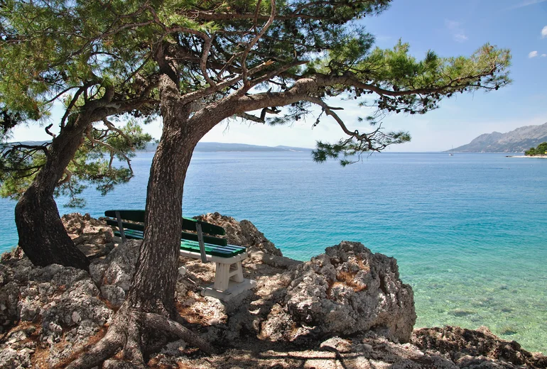 Croatian harbour town with stone houses and small fishing boats