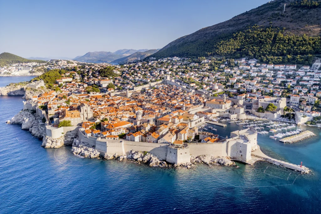 Aerial of Dubrovnik walled old town and old harbor