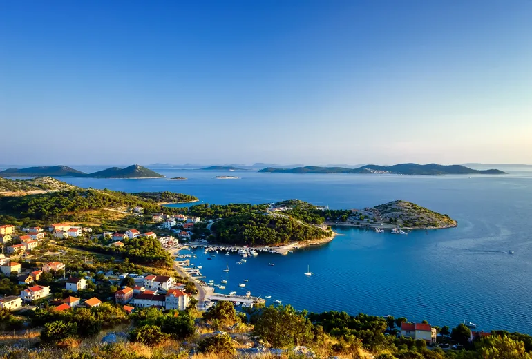 Elevated view over Žut bay with moored yachts and scattered Kornati islands beyond