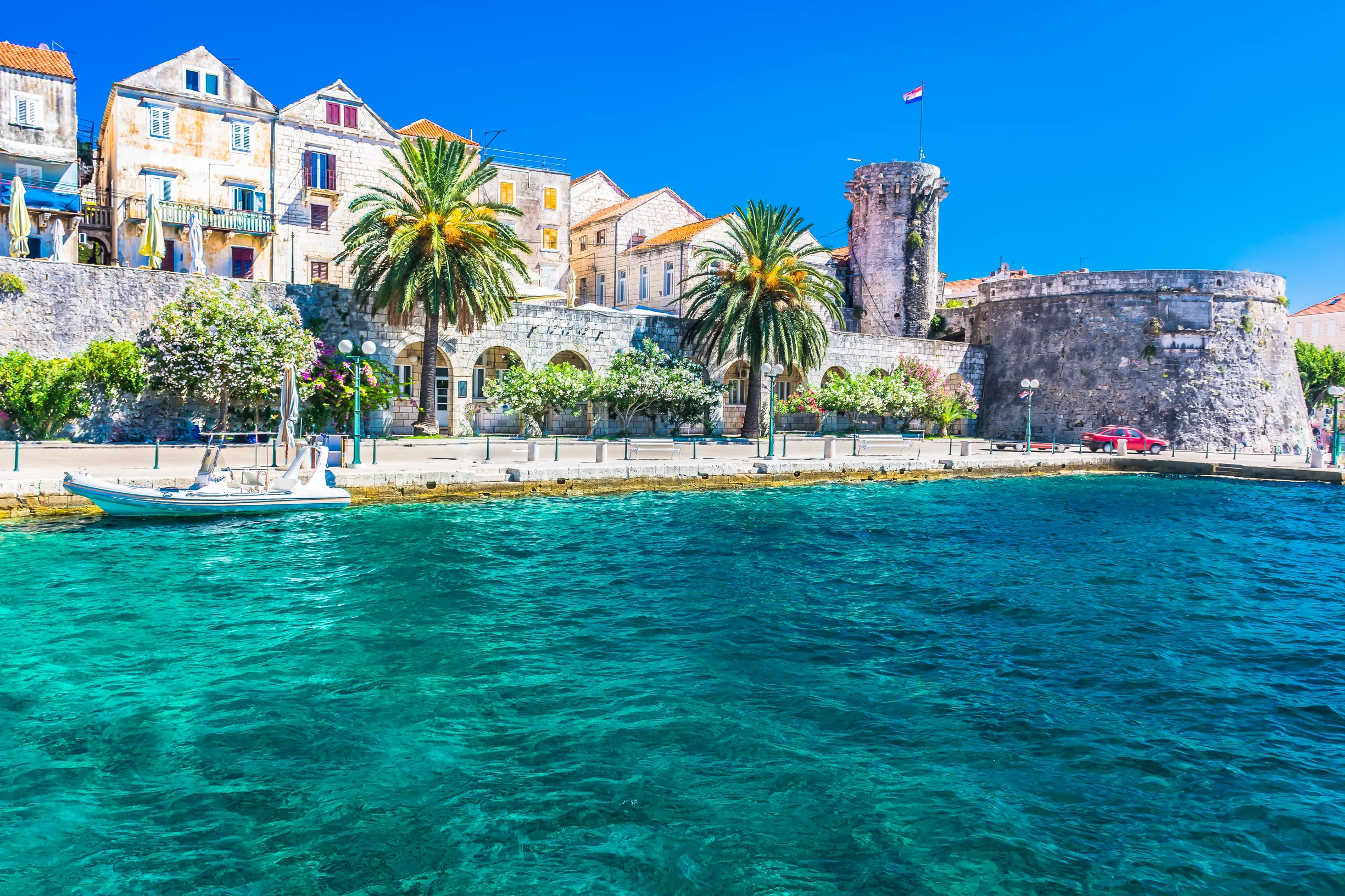 Korcula old town walls and towers above clear turquoise waterfront